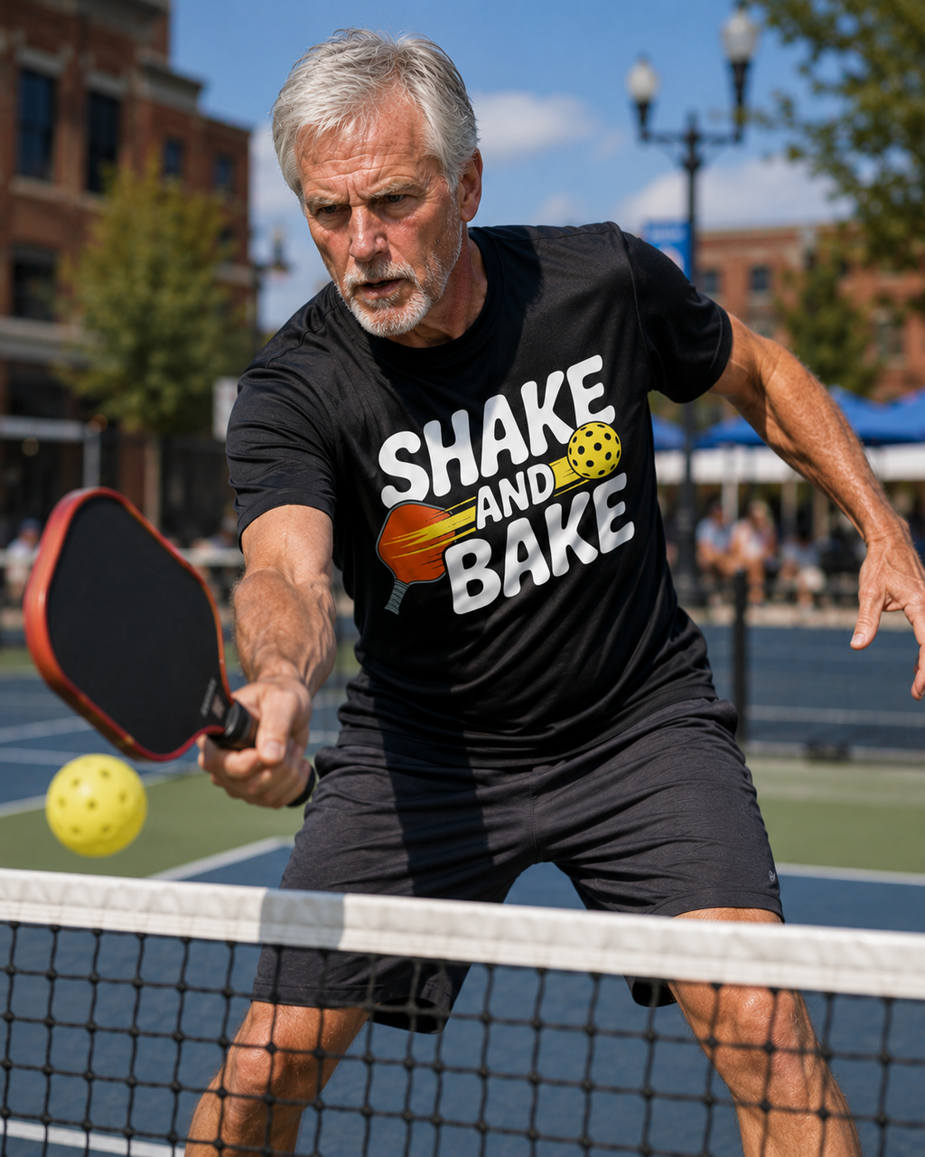 Man playing pickleball wearing a Shake and Bake moisture-wicking graphic tee in black – FunzyGear