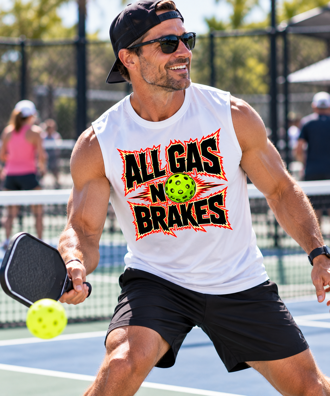 Man playing pickleball in a white sleeveless “All Gas No Brakes” shirt with a neon green pickleball graphic.
