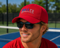 Load image into Gallery viewer, Man wearing a red cap with 'BALLER' on it and sunglasses, standing on a pickleball court.