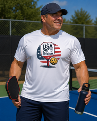 Load image into Gallery viewer, "Man wearing Patriotic Pickleball 250th Anniversary moisture-wicking paddle graphic t-shirt"