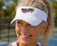 Load image into Gallery viewer, Woman wearing a white visor with 'Pickleball' branding on a pickleball