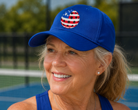 Load image into Gallery viewer, Woman wearing a blue cap with a USA pickleball logo on a pickleball court