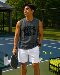 Load image into Gallery viewer, "Man wearing the Fear the Paddle Pickleball Performance Muscle Tank, displaying the bold graphic design, perfect for competitive pickleball players"